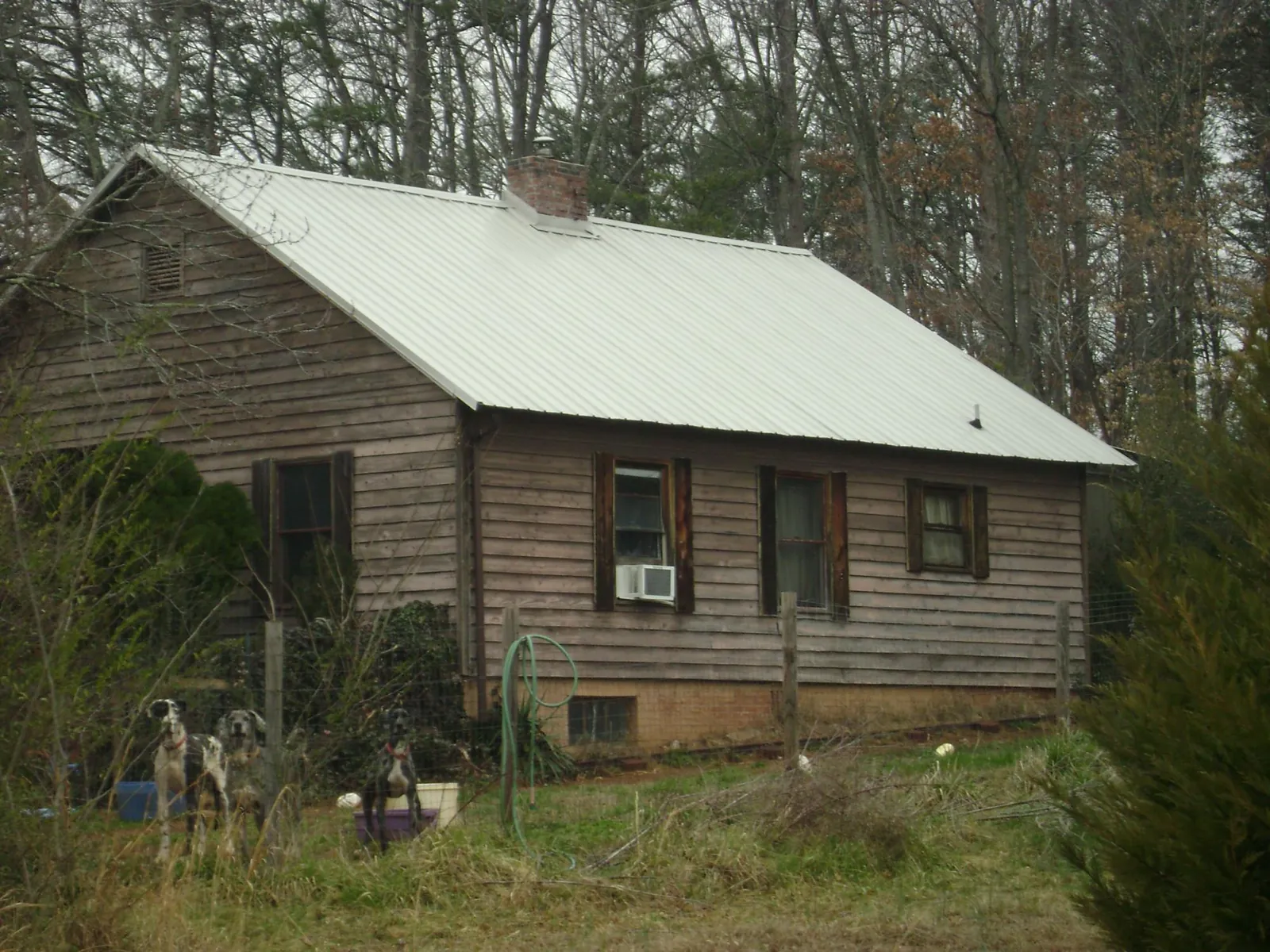 White metal roof on an old wood sided farmhouse, from a Metal Roof Installation job in Crawfordsville